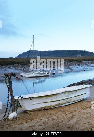 January 2022 - Calm morning with a few boats on the beach at Uphill, near Weston super Mare, In North Somerset, England Stock Photo