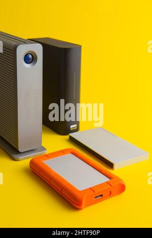 selection of external hard drives on a yellow background Stock Photo