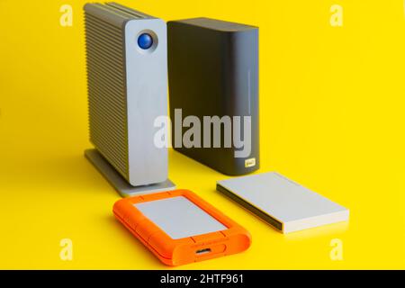 selection of external hard drives on a yellow background Stock Photo