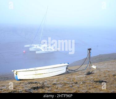January 2022 - Calm morning with a few boats on the beach at Uphill, near Weston super Mare, In North Somerset, England Stock Photo