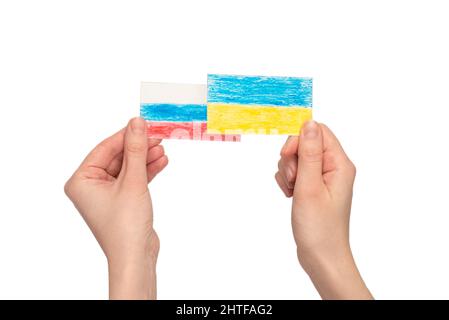 Stop war. Ukraine flag, Russia flag in woman hands isolated on a white background. Stock Photo