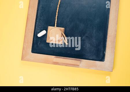 Top view of a small wall chalkboard for schedules on orange background with a copy space Stock Photo