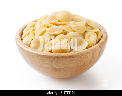 Uncooked orecchiette pasta in wooden bowl isolated on white background with clipping path Stock Photo