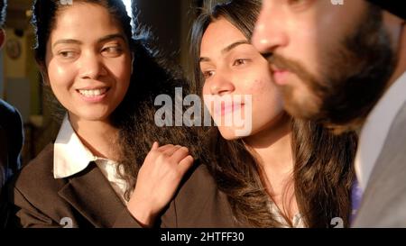 Young Indian co-workers wearing suits and smiling Stock Photo