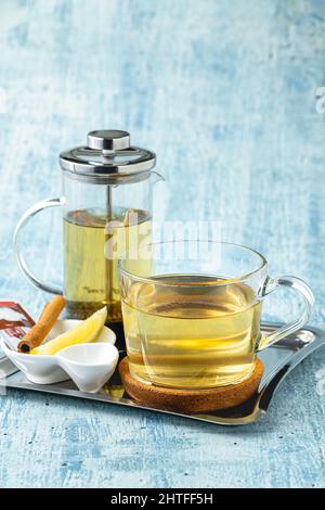 Hot winter tea served with a french press on a wooden table Stock Photo