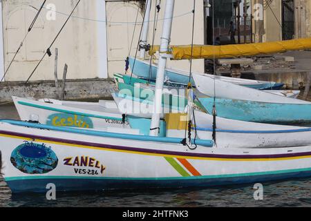 BELIZE CITY, BELIZE - JULY 6, 2016 in a line - the small fleet of fishing boats moored at the Swing Bridge with fishermen and boats from Sarteneja Stock Photo