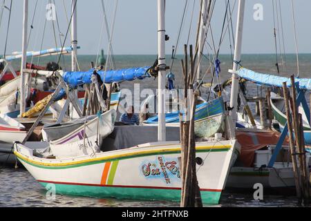 BELIZE CITY, BELIZE - JULY 6, 2016 the small fleet of fishing boats moored at the Swing Bridge with fishermen and boats from Sarteneja with the sea in Stock Photo