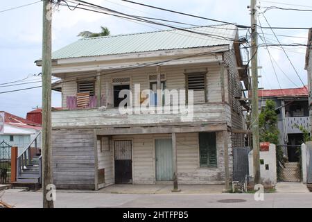 BELIZE CITY, BELIZE - SEPTEMBER 24, 2016 traditional wooden houses with green louvered windows in downtown Belize City Stock Photo
