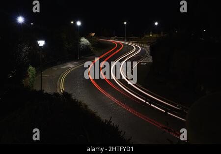 Red and white light trails on an s bend Stock Photo