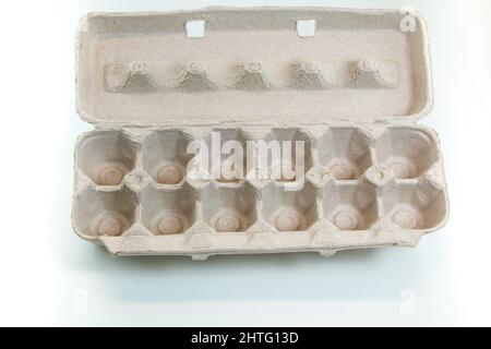 Empty, open eggs carton on a white background. Studio shot with copy space. Stock Photo