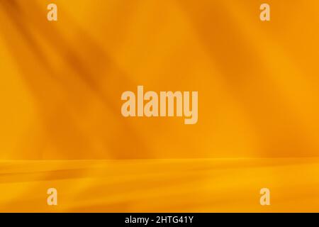 Empty yellow studio space with deep artistic shadow. Minimalistic space concept Stock Photo