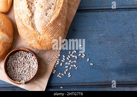 Close up view of different types of breads and pumpkin seeds with copy space on wooden surface Stock Photo
