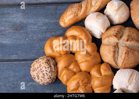 Close up view of different types of breads with copy space on blue wooden surface Stock Photo
