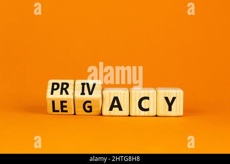 Privacy or legacy symbol. Turned wooden cubes and changed the word Legacy to Privacy. Beautiful orange table orange background. Business privacy and l Stock Photo