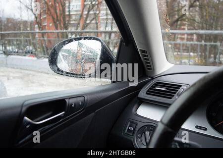 View of the cockpit through the window glass of a dark green Ferrari ...