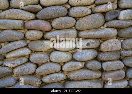 Background of gray stone wall. Stack or pile of stones cemented. Texture or background Stock Photo