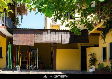 Stack of surfboards in a building for rent or sell on a sunny day Stock Photo