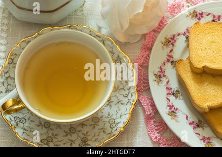 table set for breakfast or a snack with tea and rusks Stock Photo