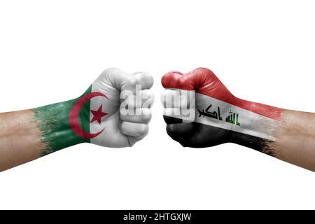Two hands punch to each others on white background. Country flags painted fists, conflict crisis concept between algeria and iraq Stock Photo