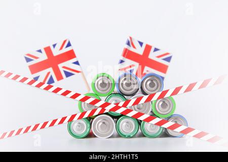 UK battery ban. Batteries are enclosed with red and white tape. Disposal of waste from batteries. Dump of electronic waste. Stock Photo