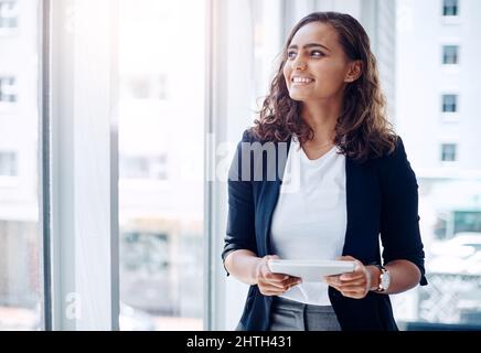 Working smarter is always worth it. Shot of a young businesswoman using a digital tablet in an office. Stock Photo
