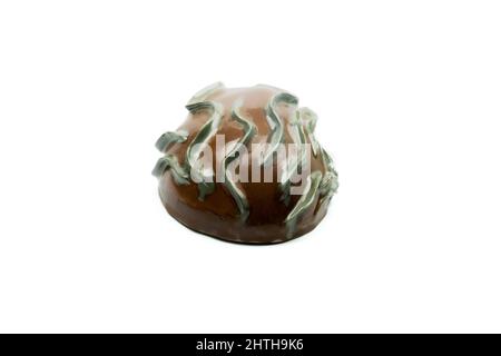 Ceramic sculpture to hang on the wall, isolated white background, side view. Stock Photo