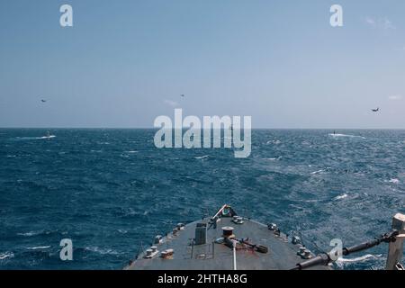 220227-N-GF955-1457  CARIBBEAN SEA - (Feb. 27, 2022) -- The Freedom-variant littoral combat ship USS Billings (LCS 15) sails in formation with the Virginia-class fast attack submarine USS Minnesota (SSN 783), the Colombian navy submarine ARC Pijao (SSK-28), Colombian navy Dauphin helicopters, and Colombian navy maritime patrol aircraft during a bilateral anti-submarine warfare exercise, Feb. 27, 2022. Billings is deployed to the U.S. 4th Fleet area of operations to support Joint Interagency Task Force South’s mission, which includes counter-illicit drug trafficking missions in the Caribbean an Stock Photo