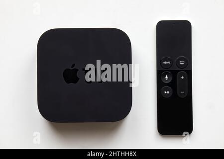 Apple TV and wireless remote on white background. Stock Photo