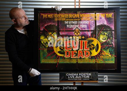 Prop Store poster consultant Mark Hochman looks at a UK quad (1st Release) for the 1981 film 'The Evil Dead' (est. £200 - £300) during a preview at their auction house in Rickmansworth, Hertfordshire. Picture date: Wednesday February 16, 2022. Stock Photo