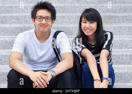 We love university. Two young students sitting outside together. Stock Photo