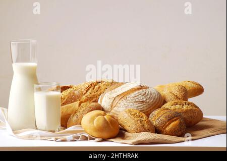 Freshly baked loaves of bread and crispy buns shot close-up Stock Photo