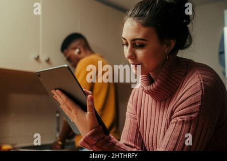Biracial couple working from home typing on digital tablet Stock Photo