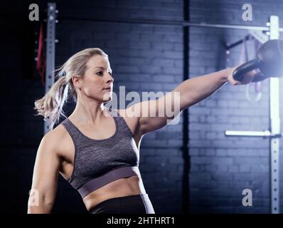 Woman doing Kettlebell Swing Stock Photo