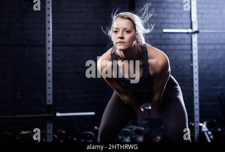 Woman doing Kettlebell Swing Stock Photo