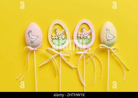 Easter decor in the form of eggs on a yellow background Stock Photo