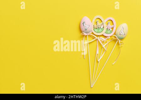 Easter decor in the form of eggs on a yellow background with copy space Stock Photo