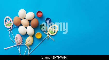 Template for easter holiday with eggs and paints and copy space Stock Photo