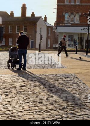 Man with pushchair - early morning in Market Place, Abingdon c3 Stock Photo