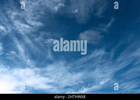 Ice crystals form in thin layers in the upper atmosphere and form wispy tendrils  of Cirrus clouds. These can develop into blanket like cirro-stratus. Stock Photo
