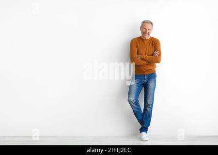 Portrait of happy mature man posing at white studio Stock Photo
