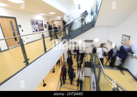 Children walking between classrooms, down school corridors and steps. Slow exposure to hide identity Stock Photo