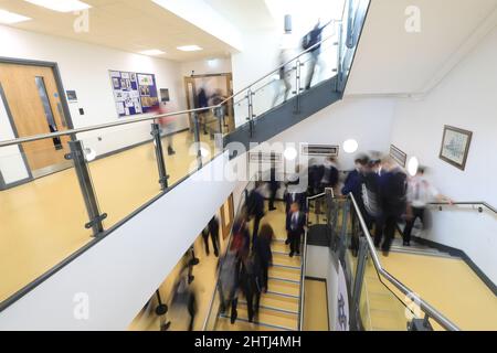 Children walking between classrooms, down school corridors and steps. Slow exposure to hide identity Stock Photo