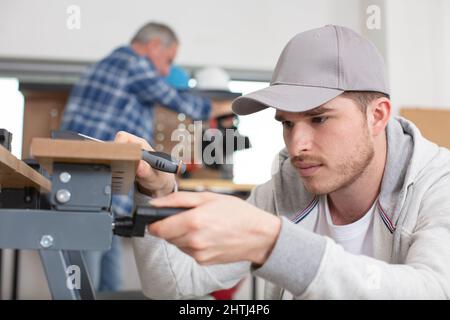 carpenter with apprentice in training period Stock Photo