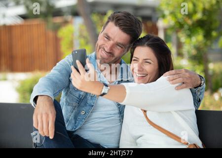 couple in love taking selfies outdoors Stock Photo