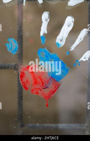 Photo of a handprint on window with bars of russian flag to support nation and be united, people must live in peace concept. Stock Photo