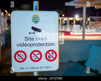 Menton, France - December 6, 2021: Translation: Site under video protection. Warning sign in the town of Menton, assuring the security of the Christma Stock Photo