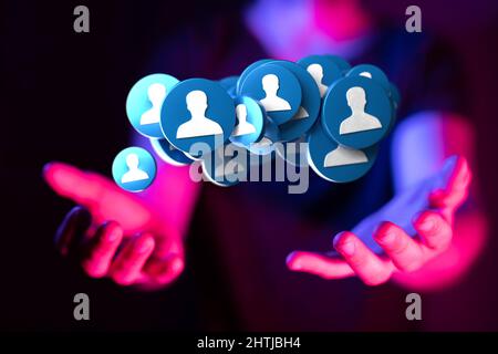 Hand holding many illustrative people circles as a communication concept. Stock Photo