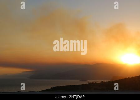 Heavy clouds of smoke rise from a massive forest fire. Landscape sky photo. Stock Photo