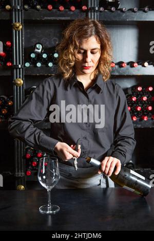 Front View On Wineglass Standing On Bar And Bartender Holding