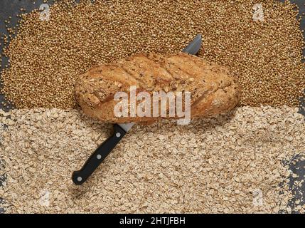 Crop senior female entrepreneur with tablet and netbook working at desk with graphics on paper sheets Stock Photo